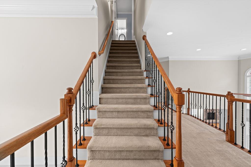 1037 Windermere Crossing Cumming, GA 30041 - Photo 59 of 95 a view of staircase with wooden floor and white walls