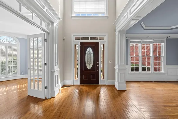 a view of an entryway with wooden floor and windows