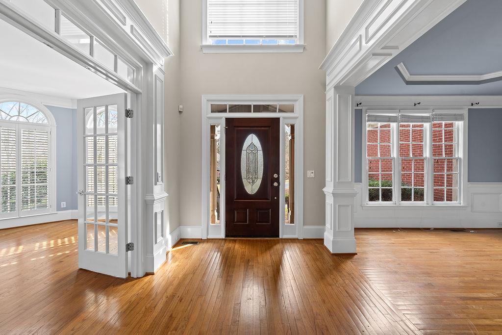 1037 Windermere Crossing Cumming, GA 30041 - Photo 6 of 95 a view of an entryway with wooden floor and windows