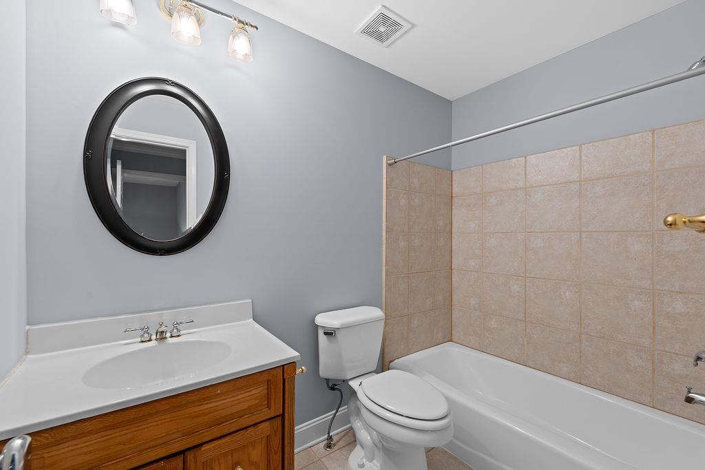 1037 Windermere Crossing Cumming, GA 30041 - Photo 62 of 95 a bathroom with a sink a toilet and a mirror