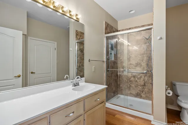 a bathroom with a shower sink and mirror
