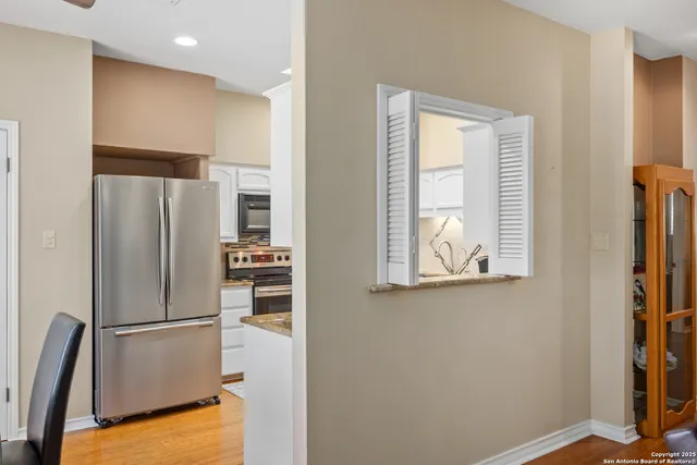 a kitchen with stainless steel appliances a refrigerator and a window