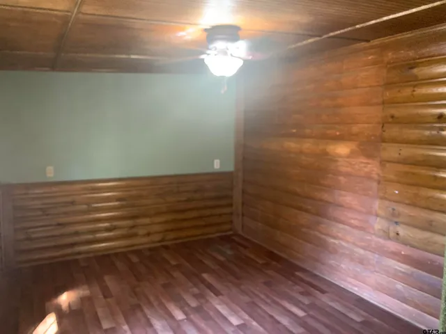 a view of room with window and wooden floor