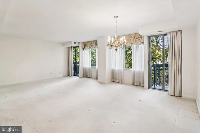 an empty room with windows and entryway