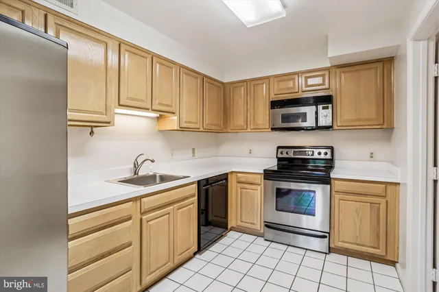 a kitchen with stainless steel appliances granite countertop a sink stove and microwave