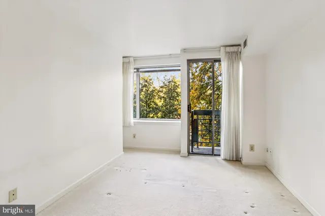 an empty room with large window