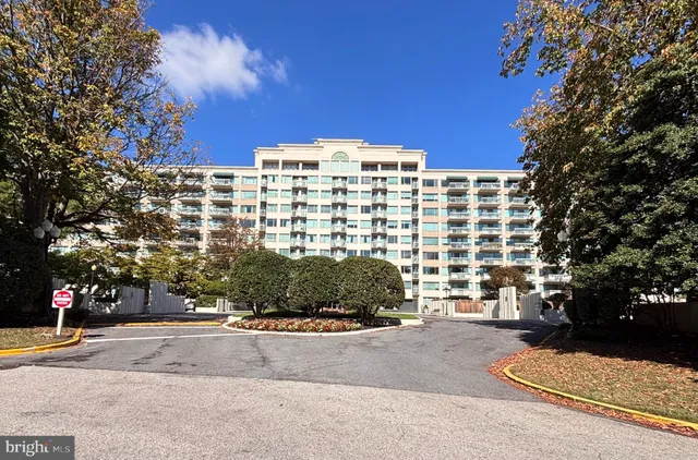 a view of a building and trees in the background