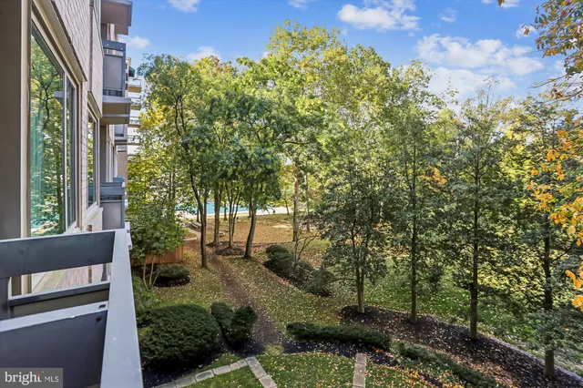 a view of a big building with a big yard and plants
