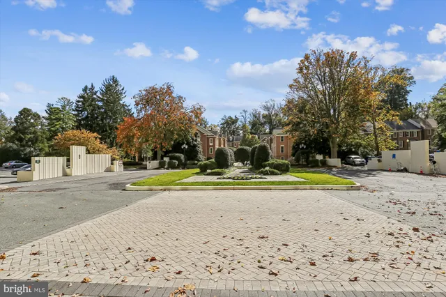 a dining room with furniture and large windows