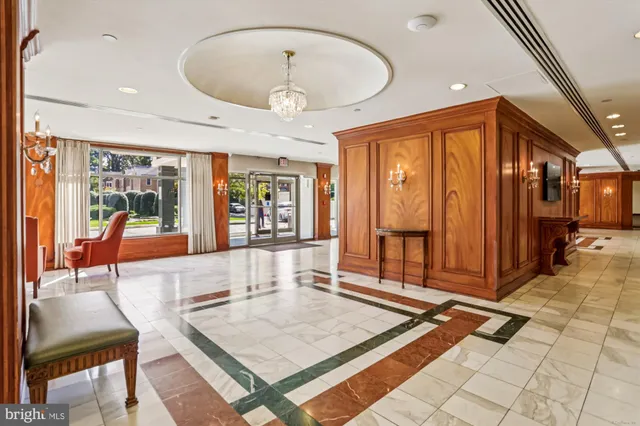 a room with a bookshelf a desk and chair