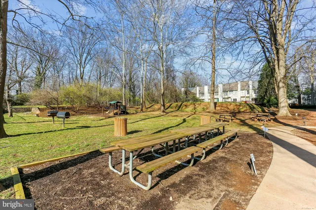 a view of a patio with table and chairs and potted plants