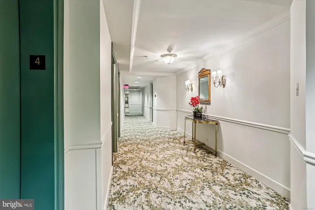 a living room with a couch and a chandelier