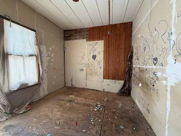 a view of an empty room with a window