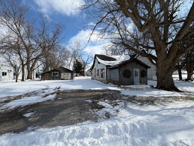 a view of a house with a yard covered in snow