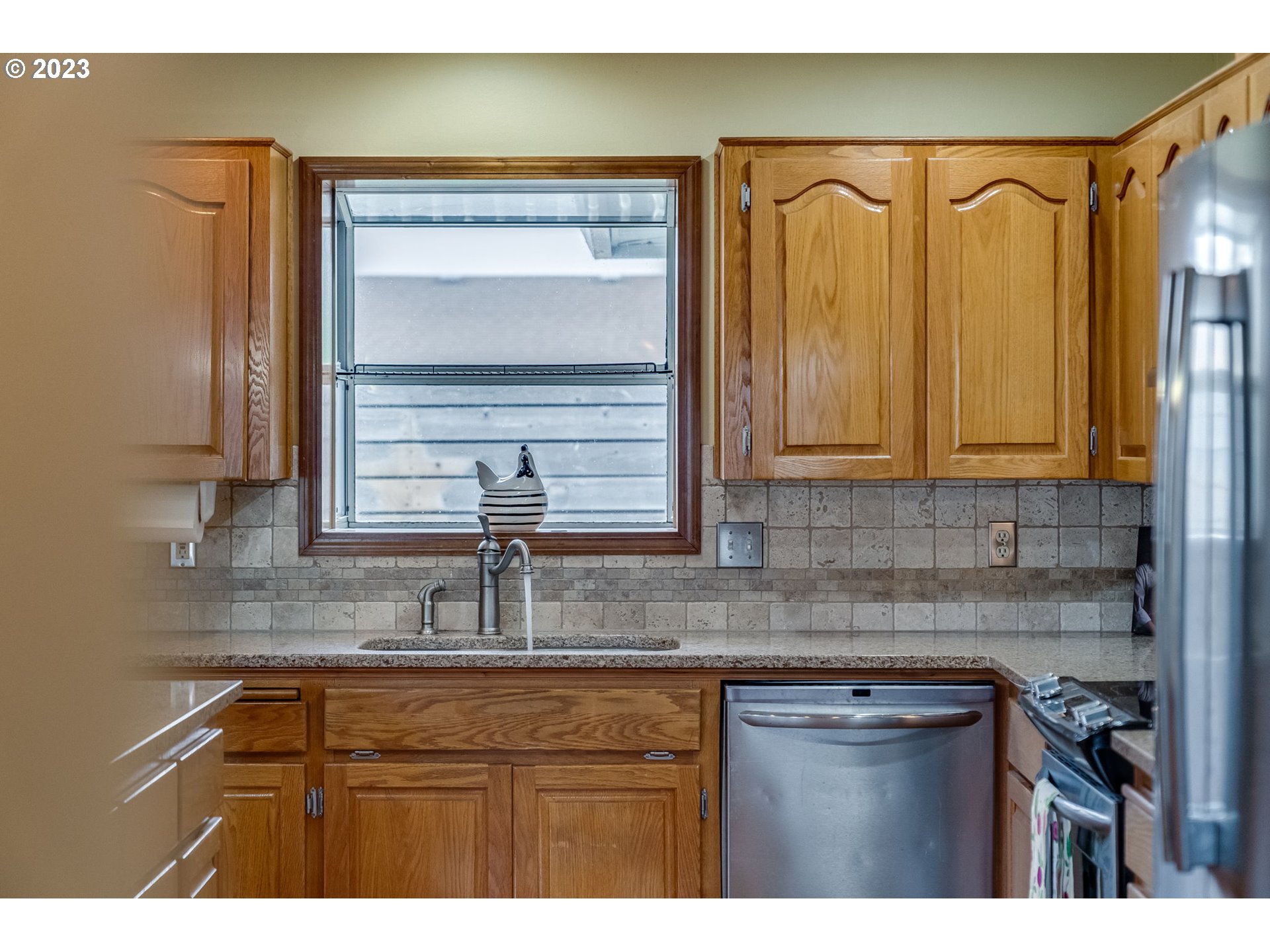 1740 North Laurelwood Loop Canby, OR 97013 - Photo 18 of 46 a kitchen with stainless steel appliances granite countertop a sink and cabinets