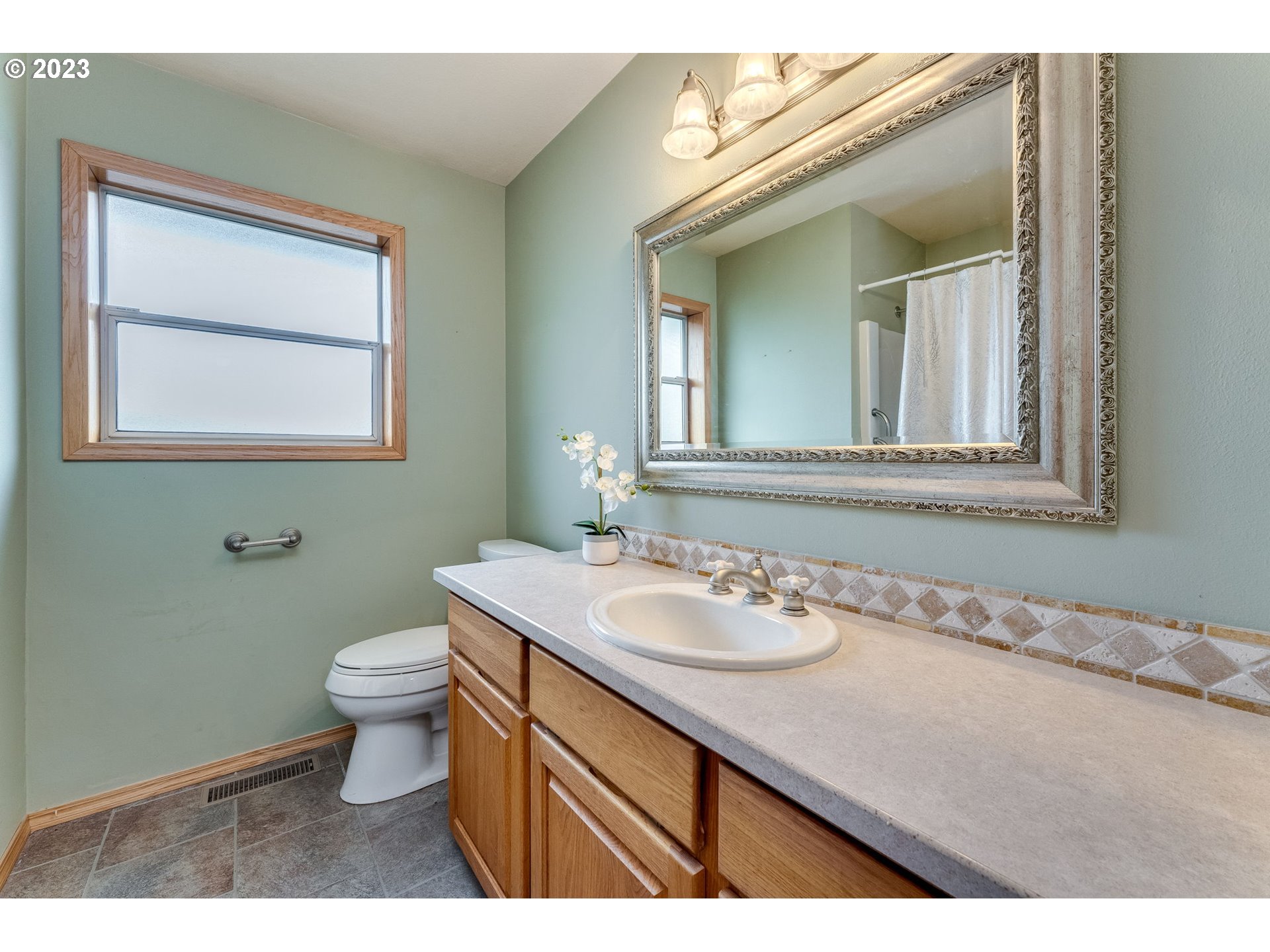 1740 North Laurelwood Loop Canby, OR 97013 - Photo 24 of 46 a bathroom with a toilet sink and mirror