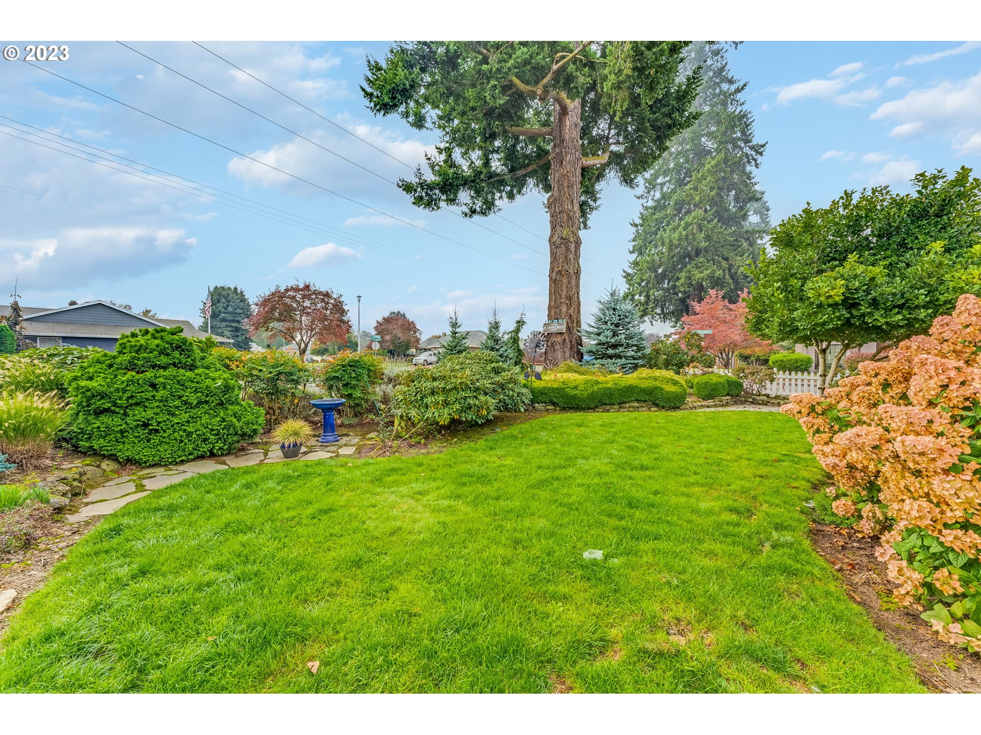 1740 North Laurelwood Loop Canby, OR 97013 - Photo 46 of 46 a view of a garden with a building in the background
