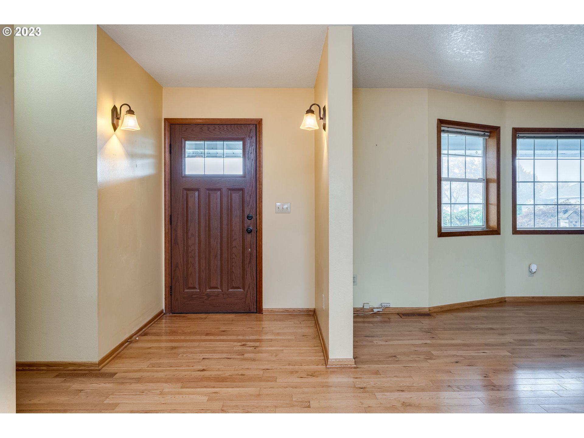 1740 North Laurelwood Loop Canby, OR 97013 - Photo 6 of 46 a view of an empty room with wooden floor and windows