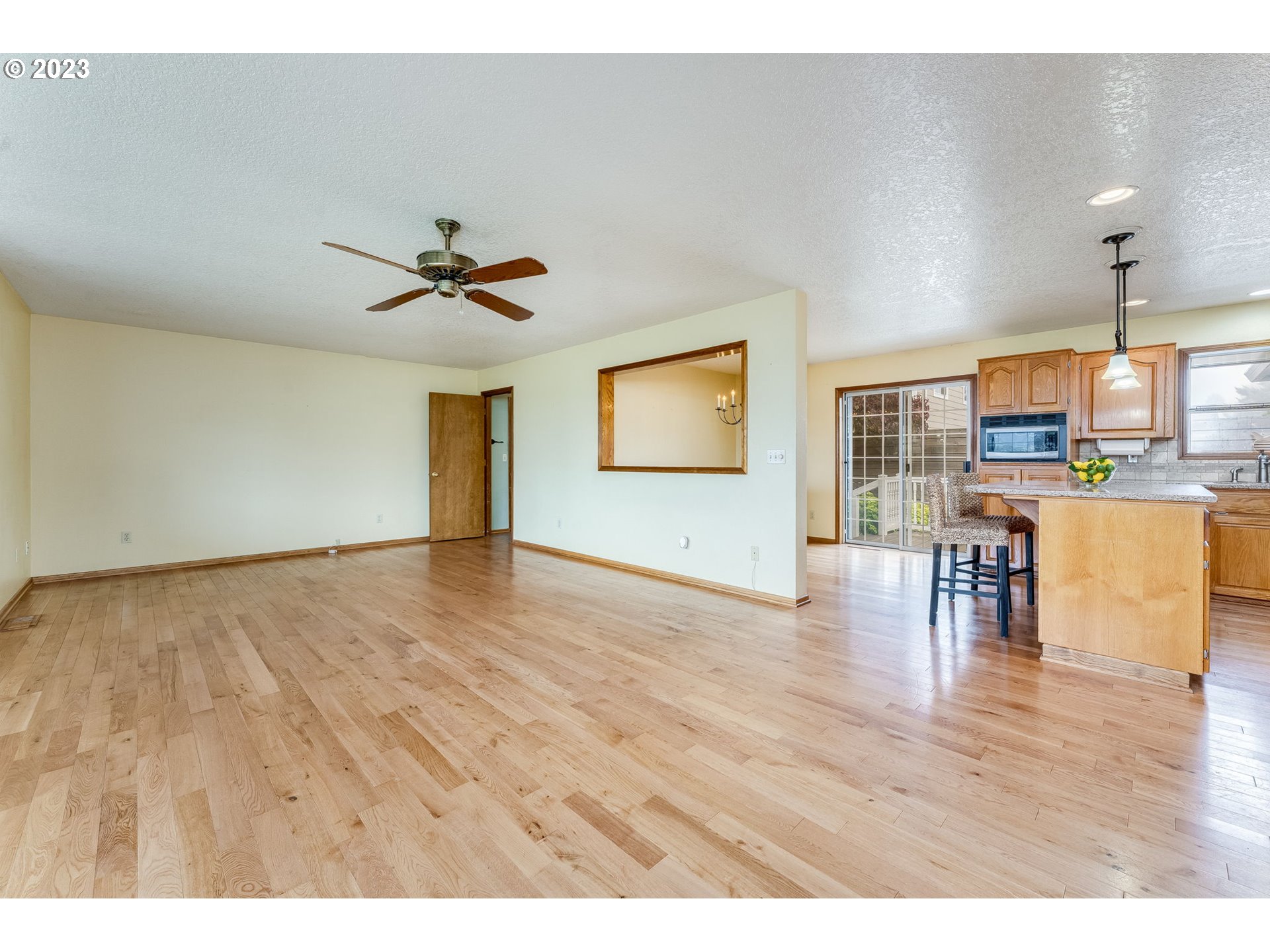 1740 North Laurelwood Loop Canby, OR 97013 - Photo 8 of 46 a view of a kitchen with furniture and wooden floor
