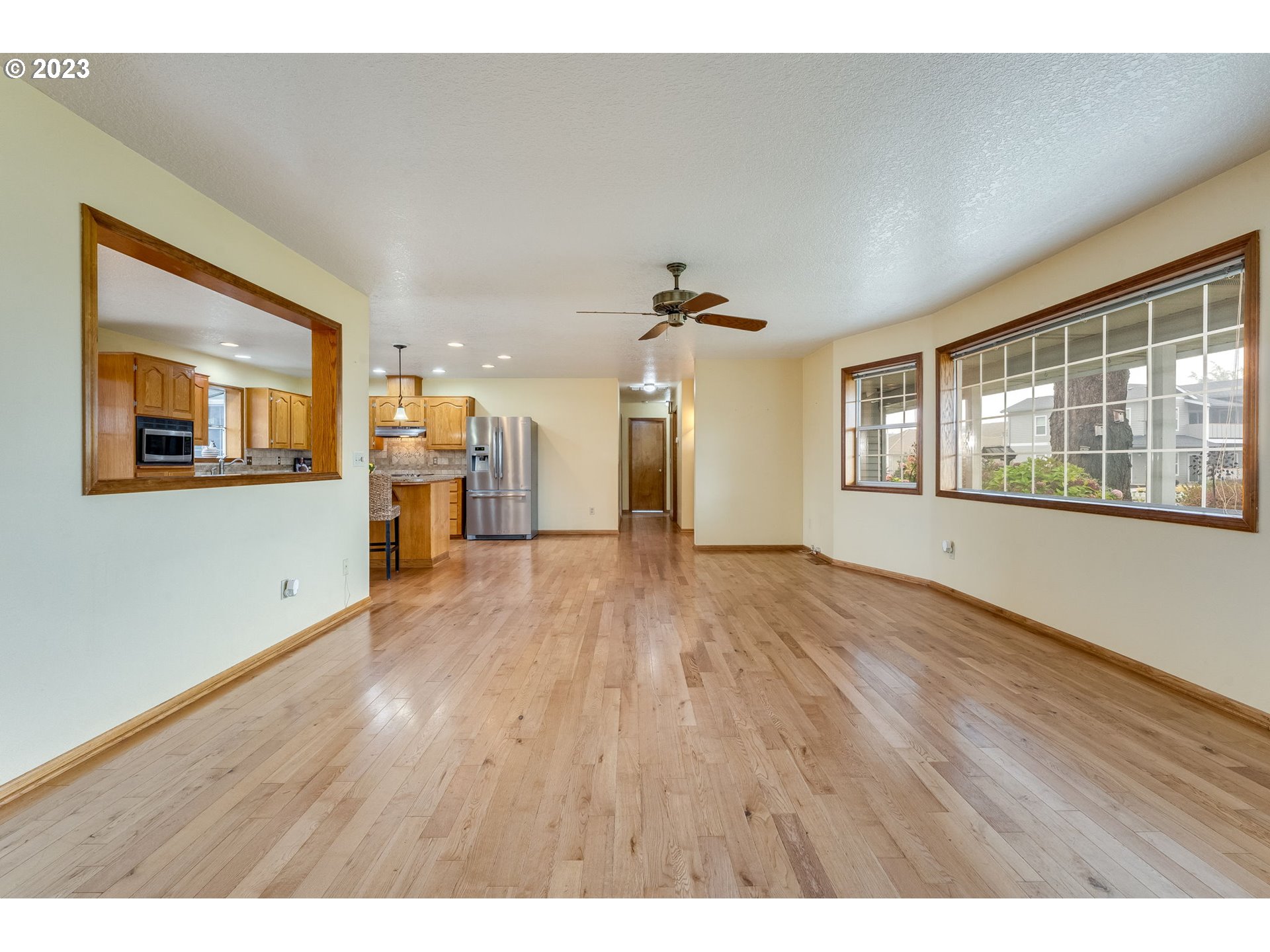 1740 North Laurelwood Loop Canby, OR 97013 - Photo 9 of 46 a view of empty room with a window and wooden floor