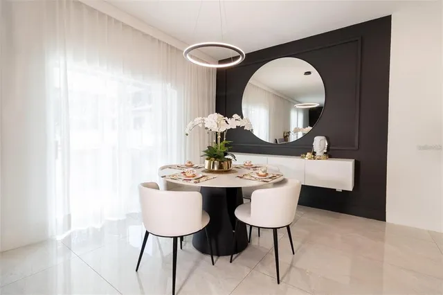 a dining room with table and chairs