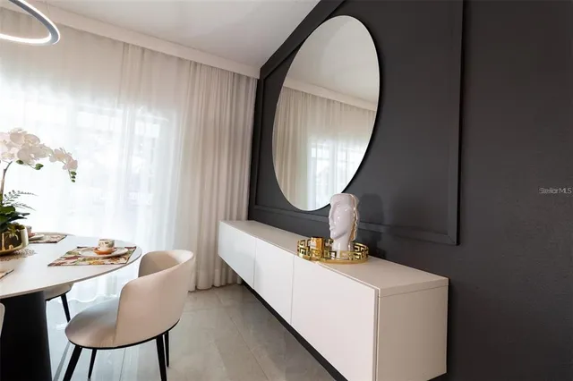 a living room with furniture and a mirror