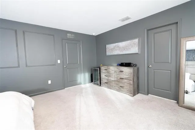 a bedroom with a bed and dresser