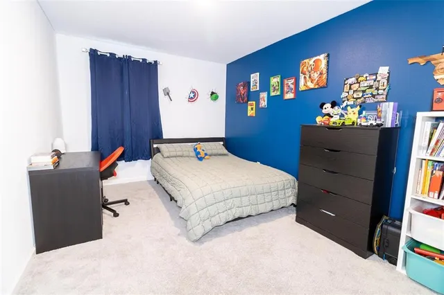 a bedroom with a bed and a dresser