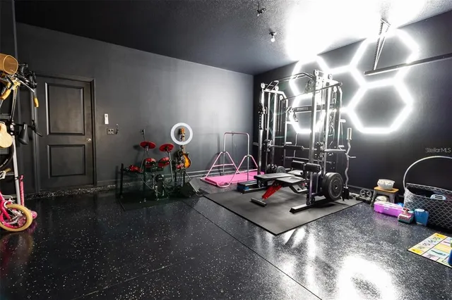 a room with gym equipment and view of living room