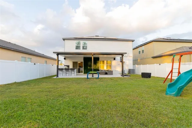 a view of an house with backyard space and balcony