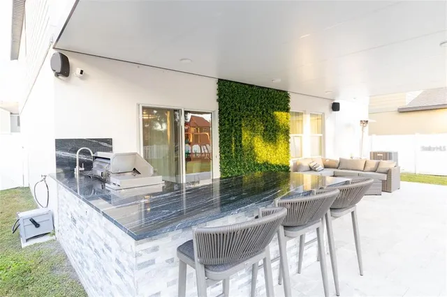 a living room with furniture a large window and a table