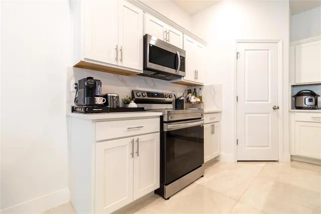 a kitchen with stainless steel appliances a stove microwave and sink