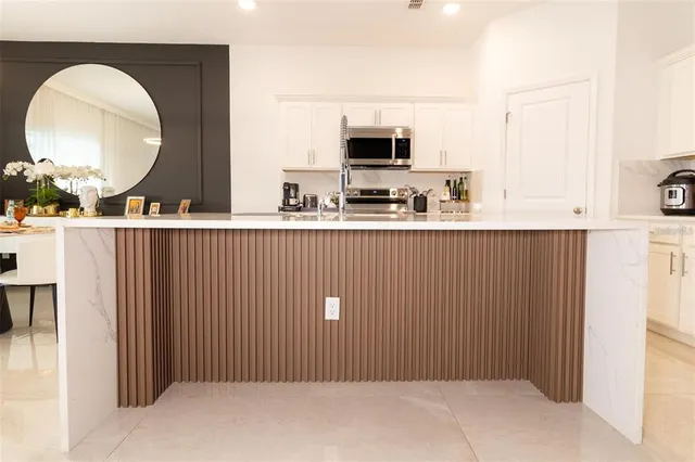 a kitchen with stainless steel appliances a refrigerator and a stove top oven