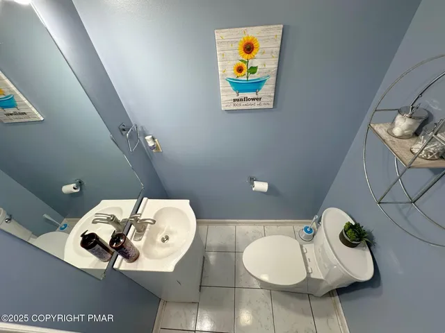 a bathroom with a sink mirror and painting on the wall