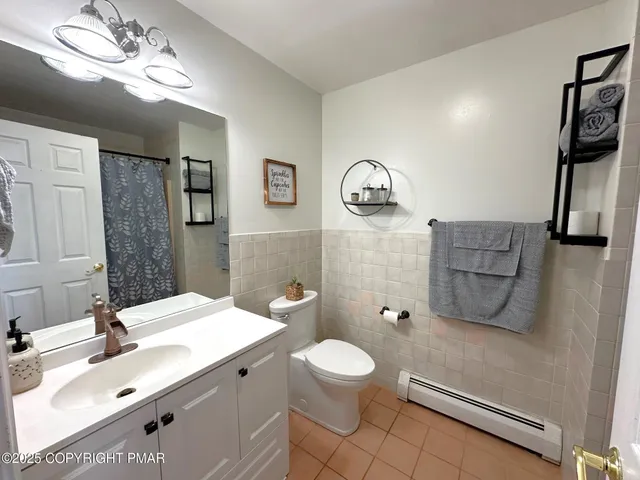 a bathroom with a sink mirror vanity and toilet