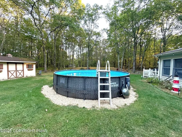 a view of a house with a yard and sitting area