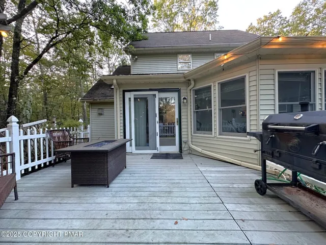 a view of a deck with table and chairs and wooden floor