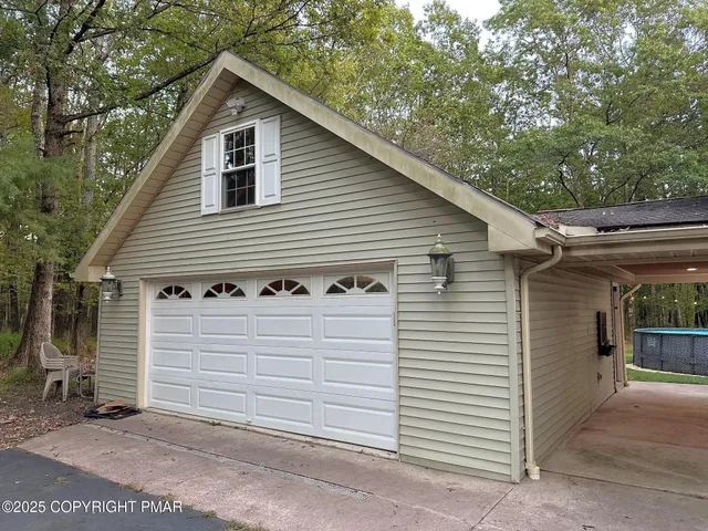 a view of a white house with a small space