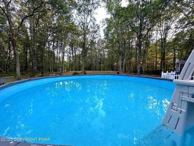 a view of a swimming pool with an outdoor space and seating area