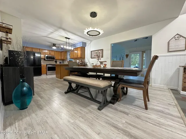 a living room with stainless steel appliances kitchen island granite countertop furniture and a large window