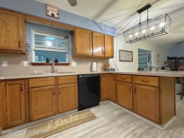 a kitchen with cabinets wooden floor and a window