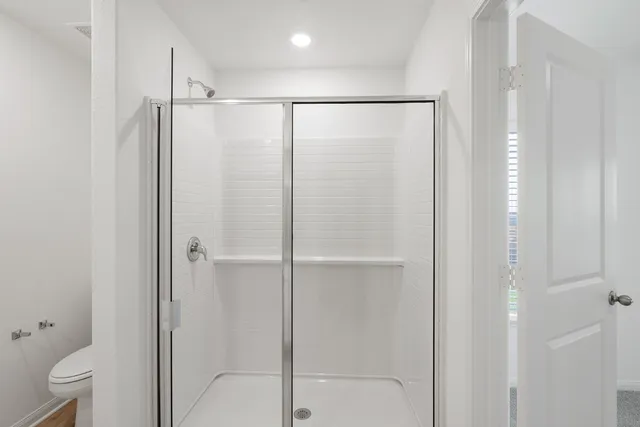 a bathroom with a glass shower door