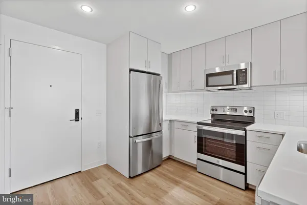 a kitchen with a refrigerator stove and microwave