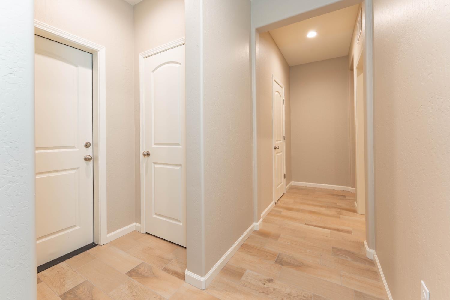 30480 Bellwood Road Visalia, CA 93291 - Photo 13 of 37 a view of a hallway with wooden floor and a bathroom