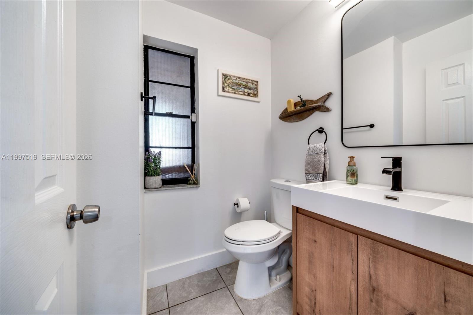 10415 Southwest 154th Court, Unit 2 Miami, FL 33196 - Photo 11 of 27 a bathroom with a sink toilet and vanity