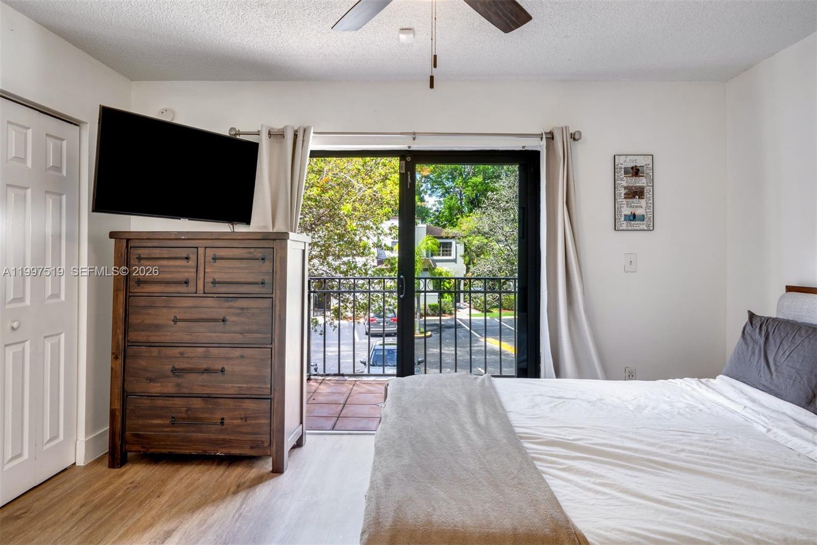 10415 Southwest 154th Court, Unit 2 Miami, FL 33196 - Photo 13 of 27 a bedroom with a bed and wooden floor