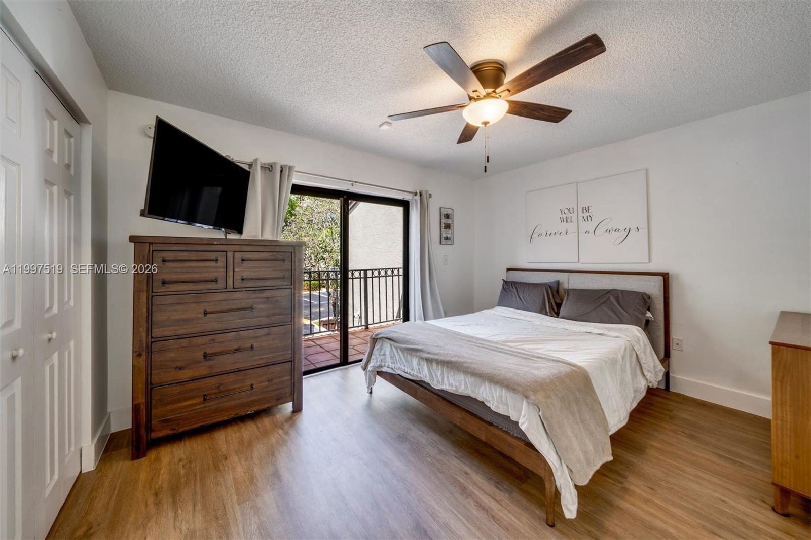 10415 Southwest 154th Court, Unit 2 Miami, FL 33196 - Photo 14 of 27 a bedroom with a bed and a television