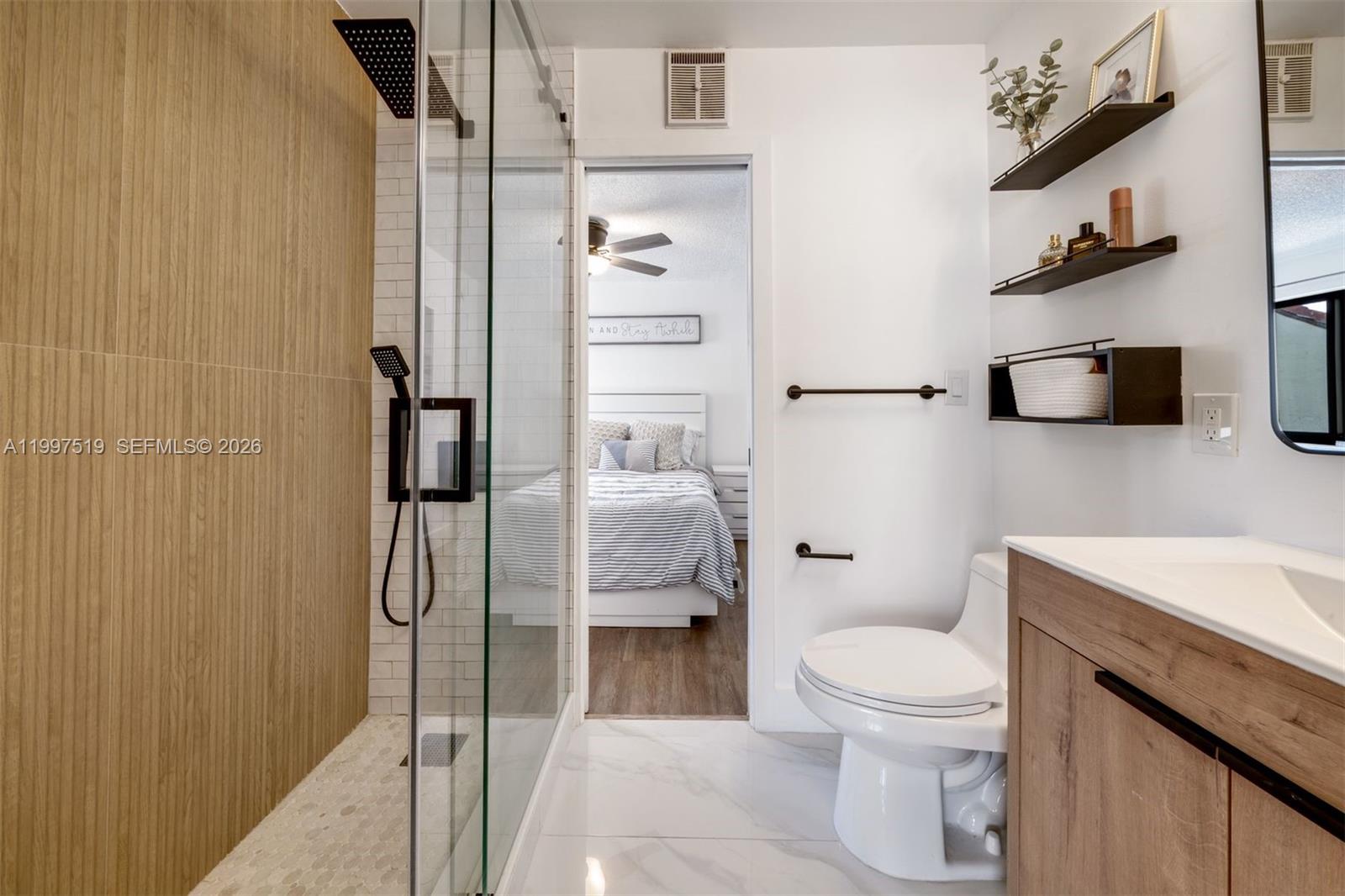 10415 Southwest 154th Court, Unit 2 Miami, FL 33196 - Photo 18 of 27 a white toilet sitting next to a bathroom sink