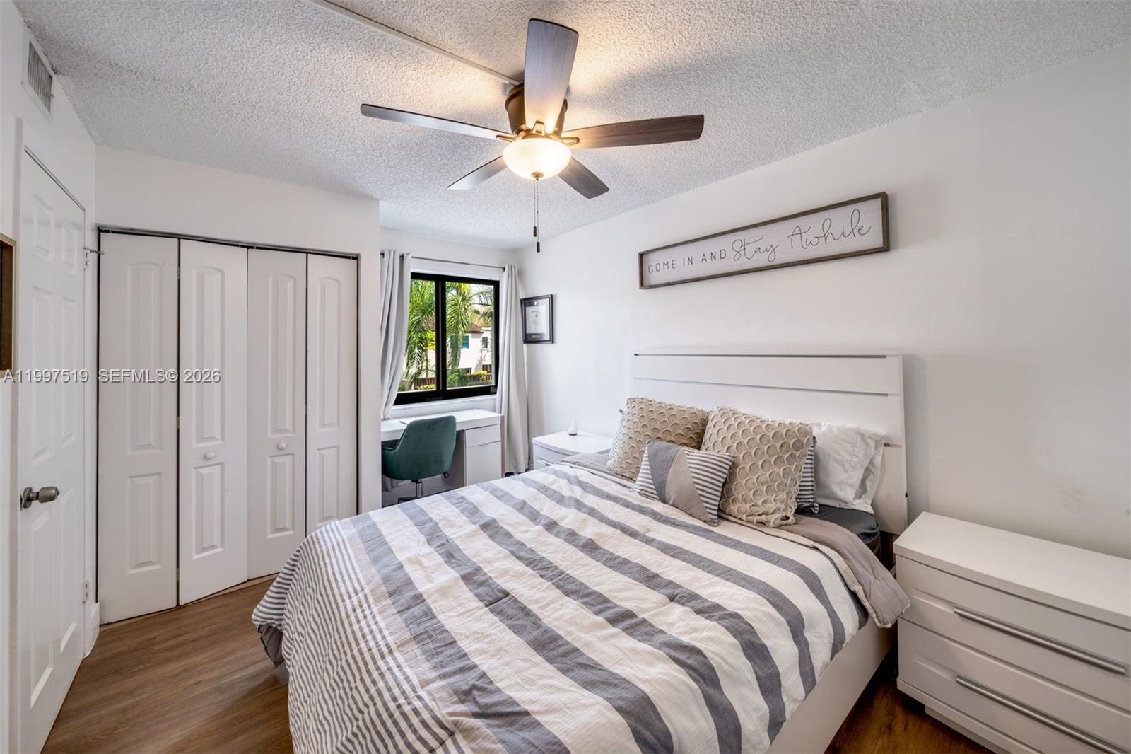 10415 Southwest 154th Court, Unit 2 Miami, FL 33196 - Photo 20 of 27 a bedroom with a bed and a chandelier