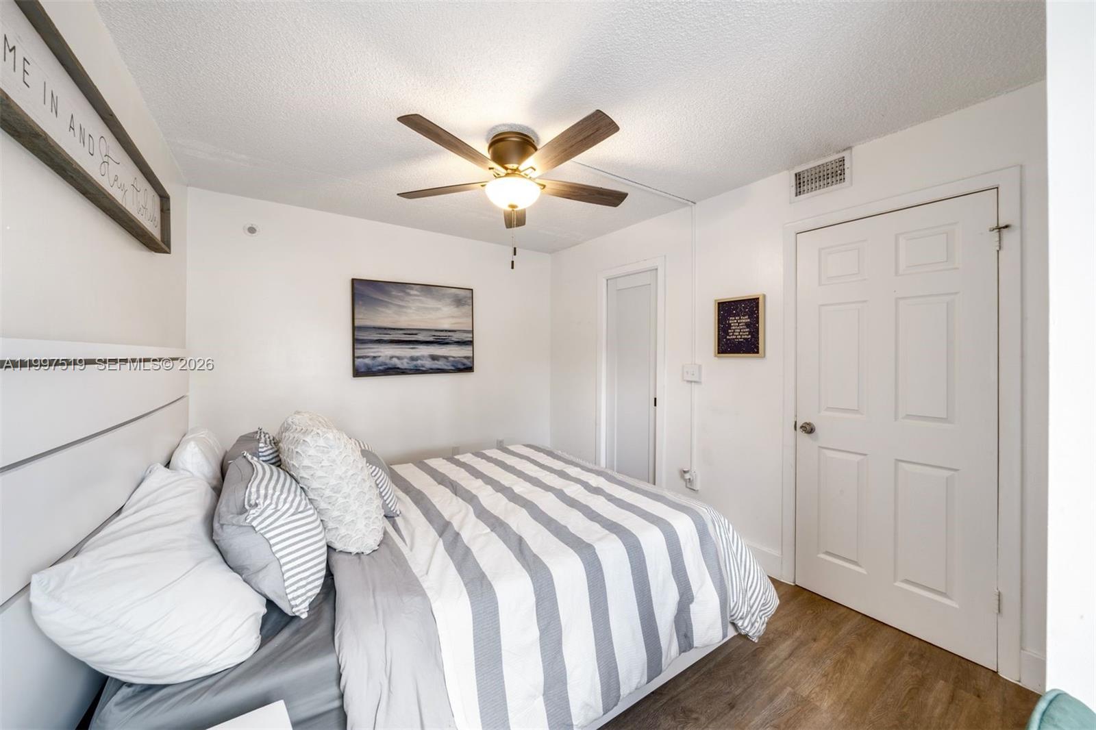 10415 Southwest 154th Court, Unit 2 Miami, FL 33196 - Photo 21 of 27 a bedroom with a bed and a chandelier